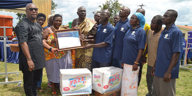 Nyamebekyere community members receiving Cleanest Community competition award